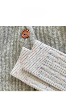 Detailed close-up of cream confetti knit socks with colorful speckles and ribbed cuff detail