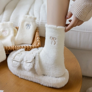 White winter plush slippers with matching crew socks featuring cute bow embroidery