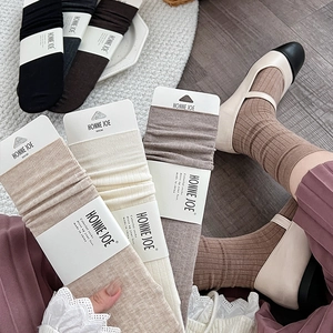 Solid color wool crew socks for women in earth tones featuring a ribbed knit texture