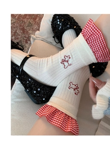 Detail of white cotton socks with red gingham ruffles and embroidered puppy design