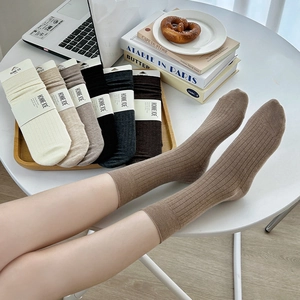 Cozy autumn winter ribbed wool blend socks in earthy tones displayed in a lifestyle setting