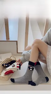 Close-up of cute penguin embroidery on cotton knit crew socks in various colors