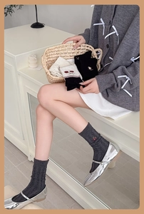 Detail view of cute wool crew socks with cherry embroidery and cable knit texture