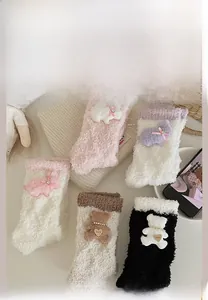 Detailed view of plush coral fleece socks featuring cute bear and rabbit patches in five colors