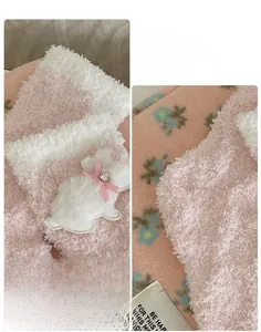 Detail of coral fleece sock with plush bunny patch, 3D heel, and elastic cuff design