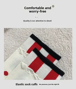 Detail of the elastic striped cuff on soft cotton socks with red and black accents