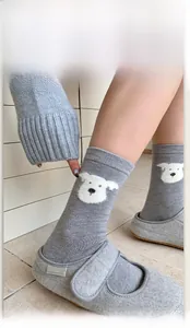 Close-up of grey socks featuring a cute puppy jacquard design and high elastic cuffs
