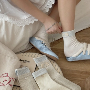 Blue and gray striped crew socks with button labels and bow patterns for women