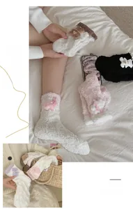 Detail of soft coral fleece socks featuring cute plush bear and bunny decorations