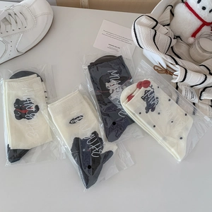Set of four cute cartoon black cat crew socks in cream and black colors with zipper pouch