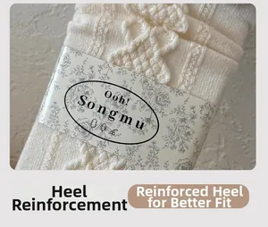Detail of cream silk wool socks with textured knit, bow detail, and reinforced heel design