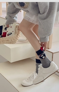 Detailed view of cartoon penguin mid-calf socks with red heart and elastic cuff