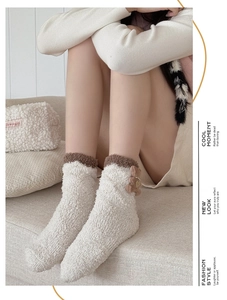 Detail of coral fleece winter sock with a 3D plush bear and golden heart pendant