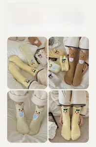 Detail of coral fleece socks featuring 3D animal ears and cute bear embroidery patterns
