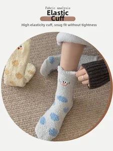 Detail of high-elasticity cuff on coral fleece socks with cat embroidery and blue dots