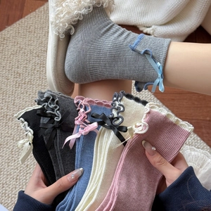 Women's ruffle trim crew socks with bow ribbons in various colors and knit texture