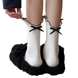White ribbed crew socks with grey ruffle trim and black satin ribbon bow for women