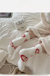 Chaussettes épaisses en polaire corail blanche avec motif pomme rouge en ambiance cosy