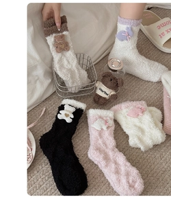 Detailed view of thick coral fleece socks with cute cartoon bear and rabbit patches
