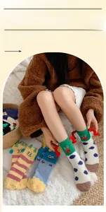 Close-up of funny clown coral fleece socks with 3D details and colorful stripe patterns