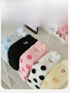 Detailed view of five pairs of thick coral fleece winter socks with cat embroidery