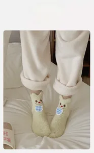 Detail of high-elasticity cuff on yellow cartoon coral fleece warm socks for women