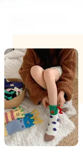 Macro shot of colorful coral fleece socks with funny 3D cartoon horns and soft texture