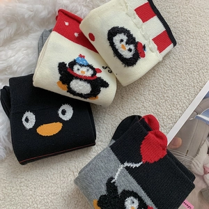 Four pairs of thick knit cotton penguin socks for winter in black, grey, cream and red