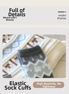 Detail view of elastic ribbed cuffs and winter snowflake jacquard on warm grey socks