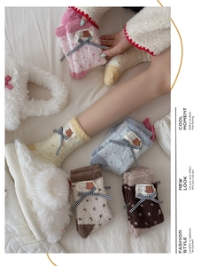 Detail of coral fleece socks with plaid bow and bear patch in multiple winter colors