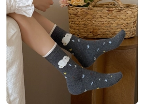 Detail of dark grey crew socks with cute cloud and star flocking patterns for women