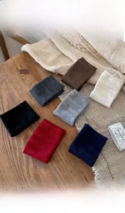 Close-up of ribbed knit wool silk socks in various solid colors on a wooden surface