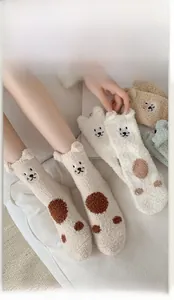 Detail of high elastic ribbed cuff on fluffy coral fleece socks with cartoon bear pattern