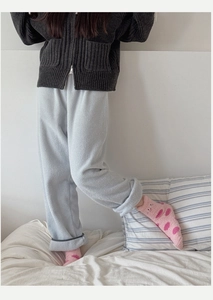 Detail of soft pink coral fleece socks with heart patterns for winter home comfort
