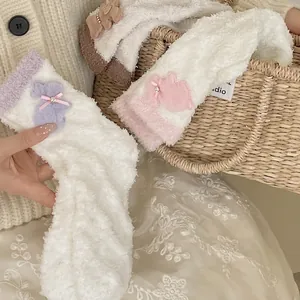 Soft coral fleece warm socks with plush bunny decor and pink ribbon bow for winter cozy wear