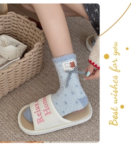 Thick coral fleece socks with bear patch and bow paired with plush open-toe slippers