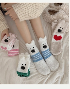 Detailed view of soft coral fleece socks featuring cute bear ears and striped patterns