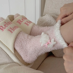 Pink coral fleece socks with cute rabbit plush and bow paired with home slippers