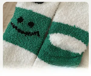 Detail shot of reinforced toe on green and white coral fleece socks with knit smile