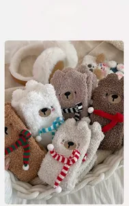 Detailed view of cozy bear coral fleece socks in varied colors inside a woven basket