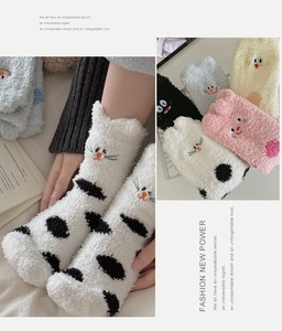 Detailed close-up of cartoon cat embroidery on thick coral fleece winter thermal socks