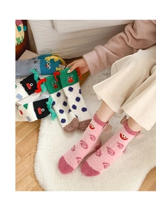Detailed view of warm coral fleece socks with funny cartoon monster 3D ears and patterns
