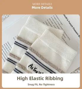 Detail of high-stretch ribbed cuff on cream striped socks with embroidered letter accents