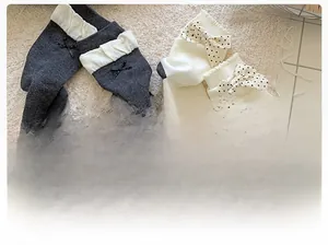 Detailed texture of cotton knit socks with polka dot bow and folded cuffs