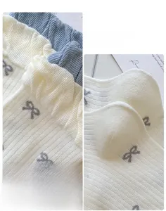 Detail of ruffled elastic cuffs and 3D reinforced heels on bow-knot knitted socks