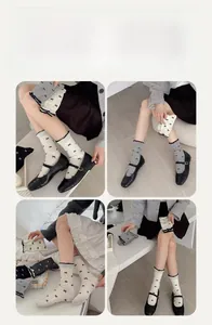 Detail of sweet cotton crew socks featuring black bow patterns and ruffled contrast edges