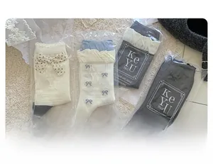 Detail of four pairs of ballet-style crew socks with polka dots and bow decorations