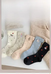 Detail of five pairs of cotton crew socks with animal embroidery and cute patterns