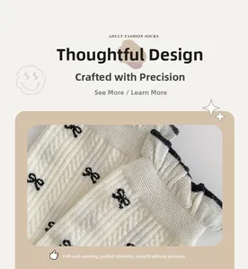 Detailed macro view of white ribbed knit socks with black bow patterns and ruffled cuffs