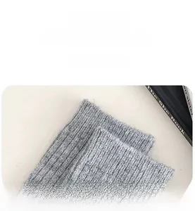 Detailed close-up of grey wool socks with thick knit texture and elastic ribbed cuffs